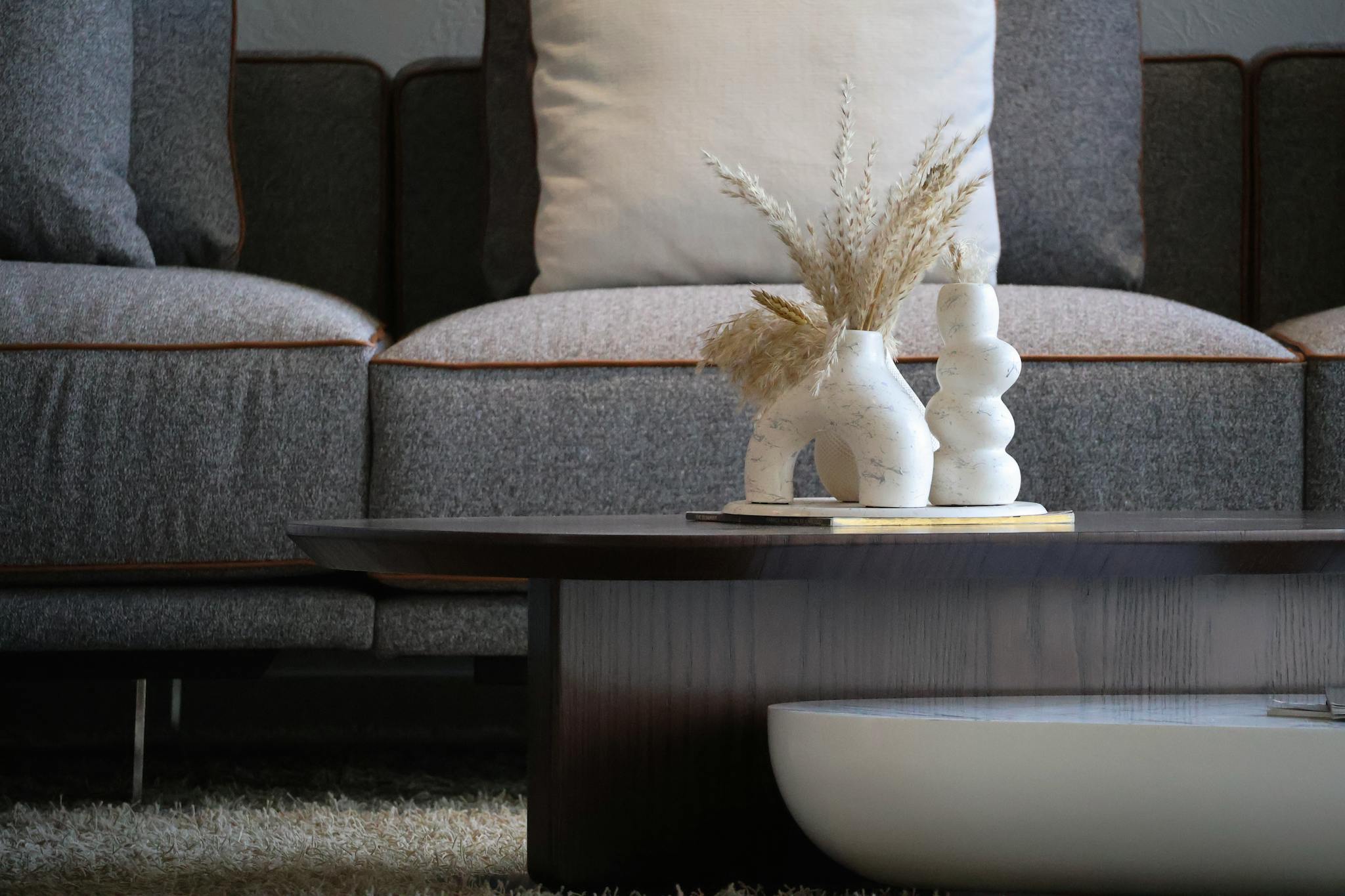 Elegant living room with modern decor featuring stylish vases and a cozy sofa.